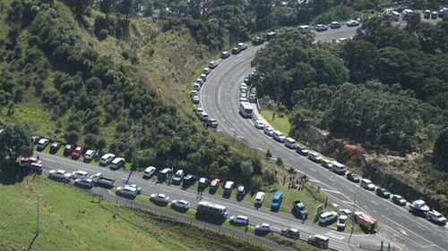 Cars parked beside the roads on higher ground as New Zealanders await a potential tsunami.