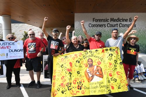 Supporters gather outside the Lidcombe Coroner's Court in Sydney, Friday, November 22, 2019. 