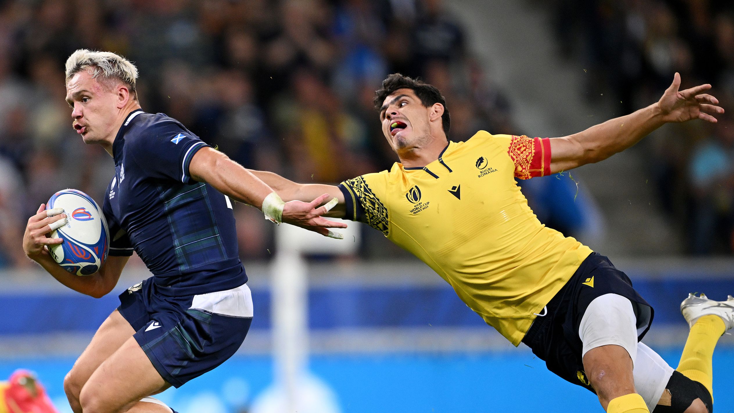 Darcy Graham of Scotland evades Marius Simionescu of Romania before scoring a try.