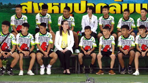 The boys sat on stage alongside medical personnel and some of their rescuers. Picture: EPA/AAP
