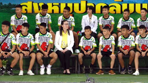 The boys sat on stage alongside medical personnel and some of their rescuers. Picture: EPA/AAP