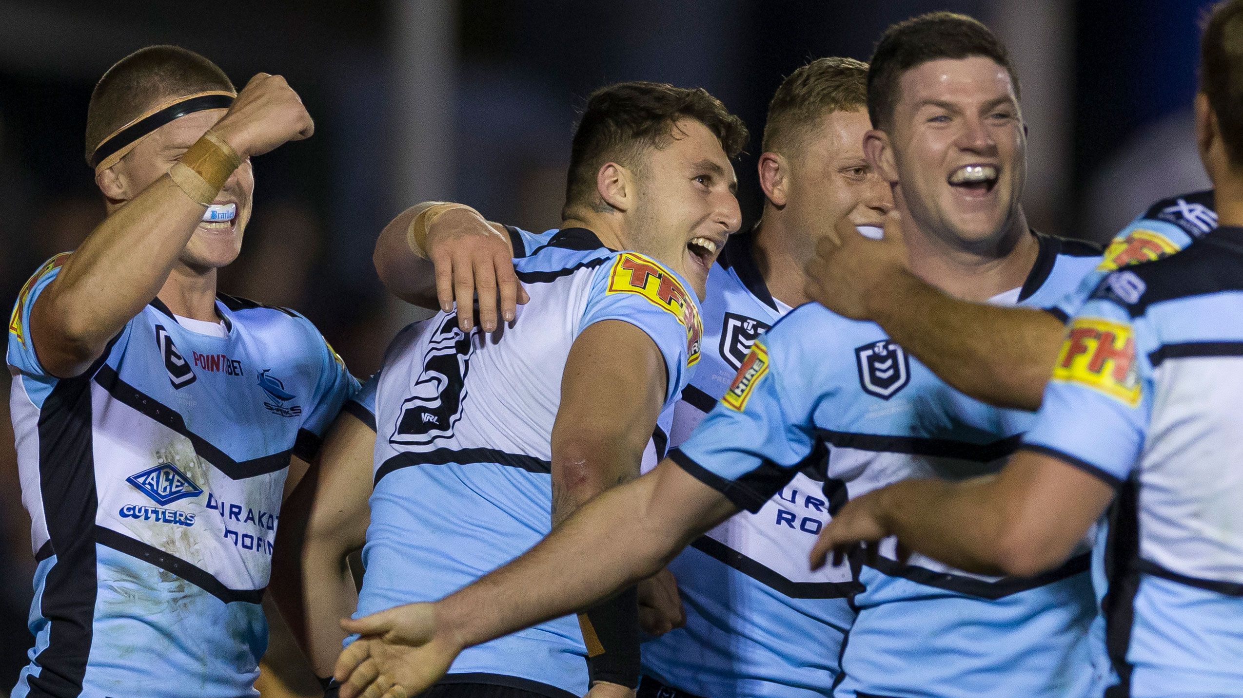 The Cronulla Sharks celebrate a try against the Rabbitohs.