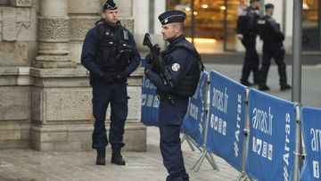 Police officers patrol during the funeral ceremony of French teacher Dominique Bernard, 57, who was stabbed to death at the school by a suspected Islamist extremist, in Arras, northern France, Thursday, Oct. 19, 2023. 