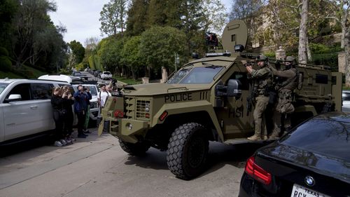 A law enforcement vehicle rumbles up to a a Beverly Hills property belonging to Sean 'Diddy' Combs.