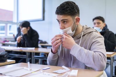 A pupil takes a Corona antigen rapid test before the start of lessons at the Katharina Henoth Comprehensive School in Cologne, Germany, Monday, April 19, 2021.