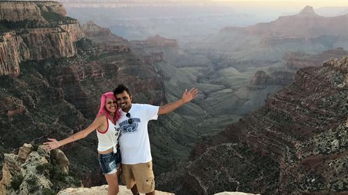 The 'travel obsessed' couple pose at the Grand Canyon.