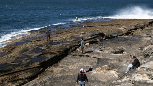 People fish during lockdown at La Perouse, Sydney.