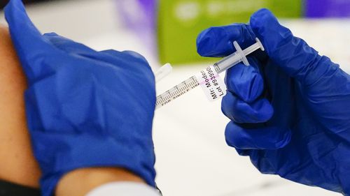 FILE - A health worker administers a dose of a Moderna COVID-19 vaccine during a vaccination clinic in Norristown, Pa. on Dec. 7, 2021. In a reversal for President Joe Biden, a federal appeals court in New Orleans on Monday, June 27, 2022, agreed to reconsider its own April ruling that allowed the administration to require federal employees to be vaccinated against COVID-19. (AP Photo/Matt Rourke, File)