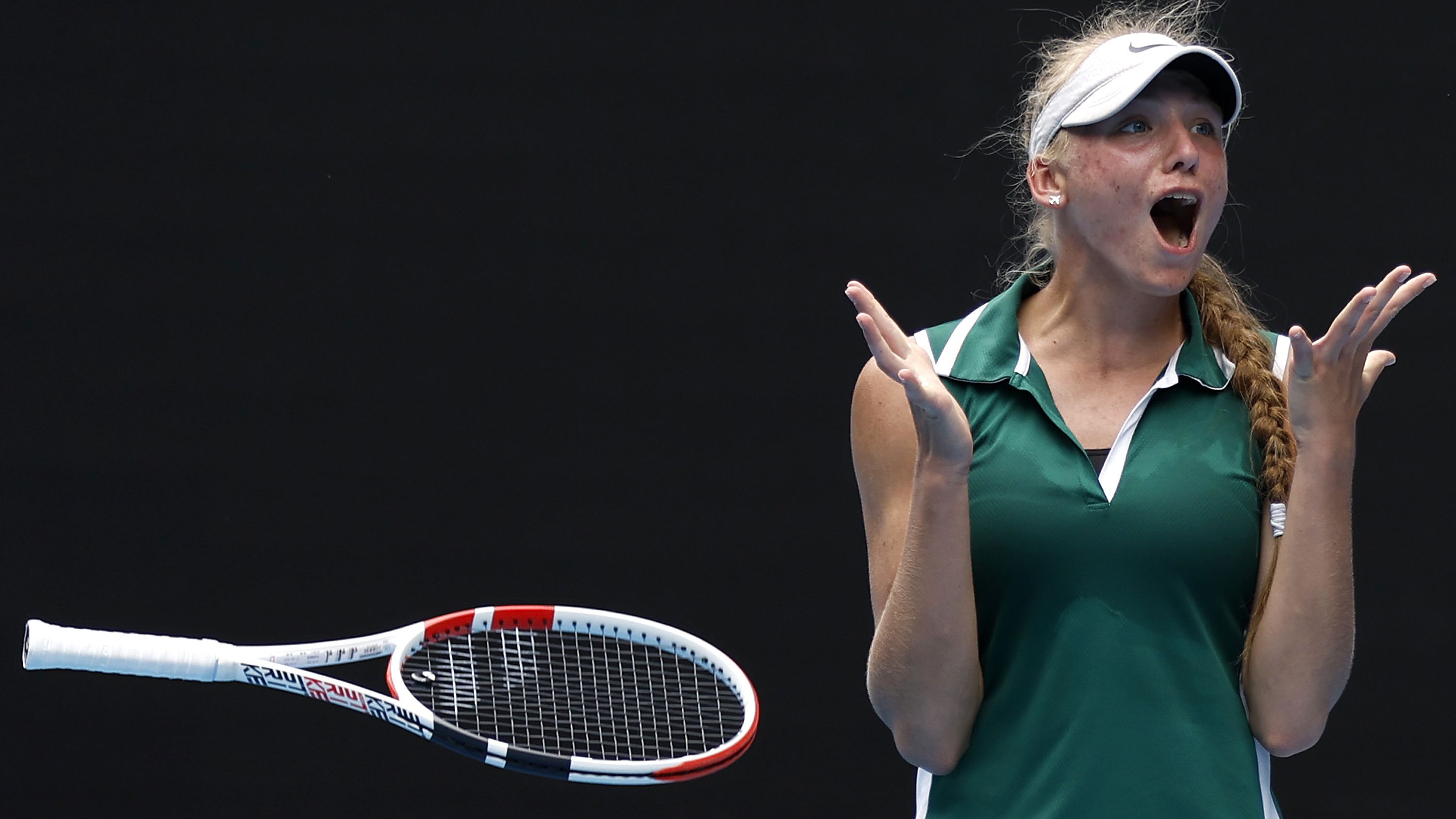 Alina Korneeva throws her racquet in the air after winning the Australian Open girls&#x27; final.