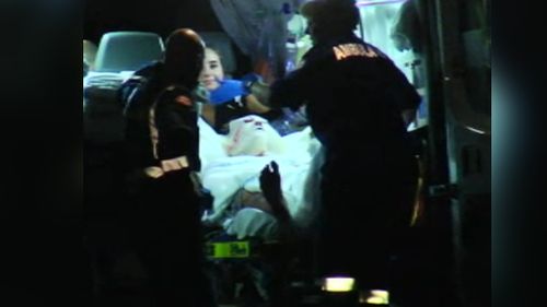 A man is loaded into an ambulance after a firework exploded on him in Sydney's south. (9NEWS)