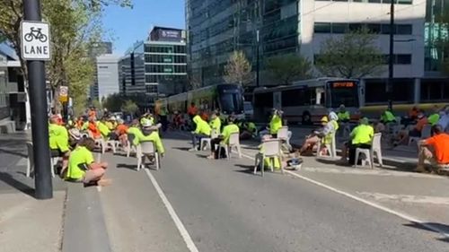 Trams and buses are stopped from going through Collins Street in Melbourne's CBD.