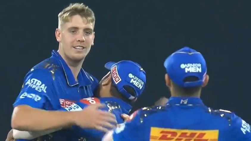 Cameron Green is congratulated by Mumbai Indians teammates after taking a crucial wicket.