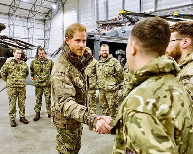 Prince Harry meeting with armed forces personnel.