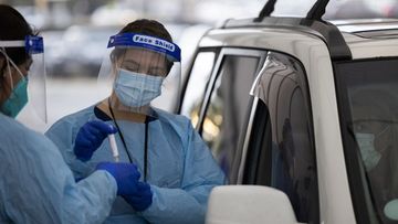 A nurse collects COVID-19 test samples at the Bondi drive-through testing clinic.