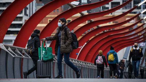 People wearing face masks near Southern Cross Station on July 14, 2022 in Melbourne, Australia.