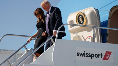 US President Donald Trump disembarks a plane with first lady Melania Trump. (AAP)