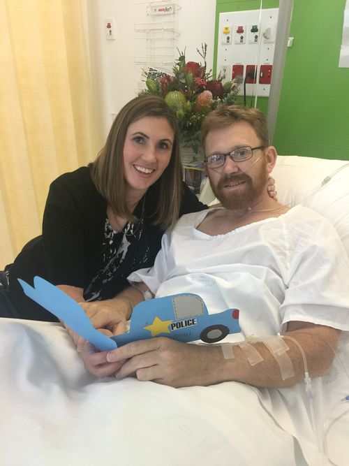 Senior Constable Luke Warburton and his wife Sandra while he was in hospital recovering.