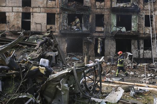 Emergency workers inspect a damaged multi-storey apartment building caused by the latest rocket Russian attack in Kryvyi Rih, Ukraine, Tuesday, June 13, 2023.  