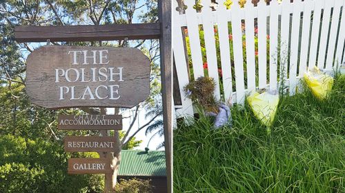 Bouquets have been left outside the site of the former restaurant. (9NEWS/Ehsan Knopf)