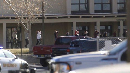 Students are led out of Aztec High School after a shooting