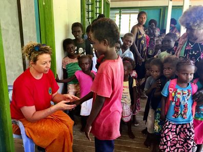 Dr Lucia Romani working with children in the Pacific.
