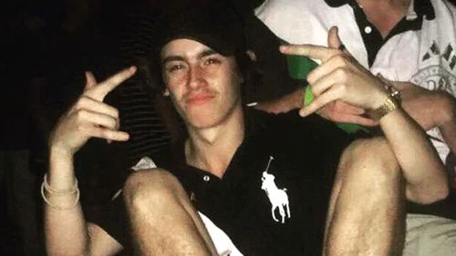 Police say Cian English was trying to escape being robbed at knifepoint when he fell from the fourth storey of a Gold Coast building on the weekend.