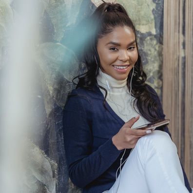 Woman with phone in her hand, sitting down