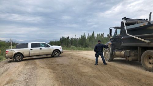 Police checking cars and trucks going in and out of Gillam.