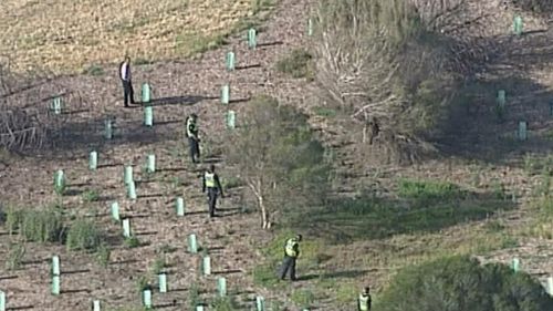 Police conducting a line search at Cherry Lake Reserve in Altona where a woman was attacked. (9NEWS)