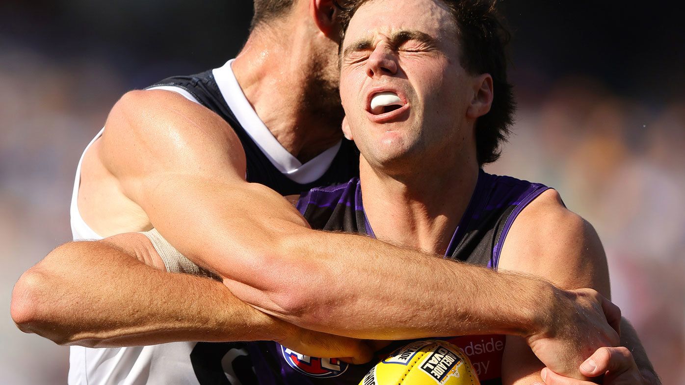 Jordan Clark of the Dockers is tackled by George Hewett of the Blues during Gather Round.