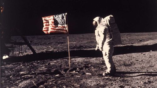 Buzz Aldrin stands beside the American flag on the moon, in a photo taken by Neil Armstrong.