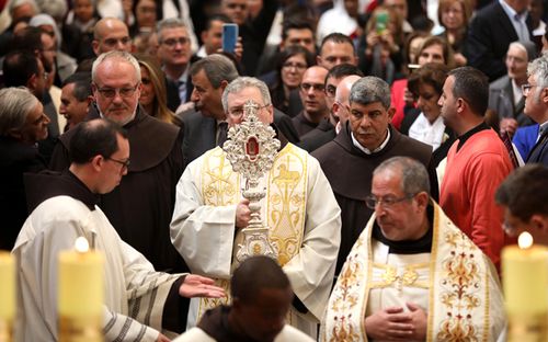 The chief custodian for the Holy Land, Francesco Patton, holds the Relic of the Holy Crib of the Child Jesus, a gift from Pope Francis to the Custody of the Holy Land, during a procession to the church of St Saviour.