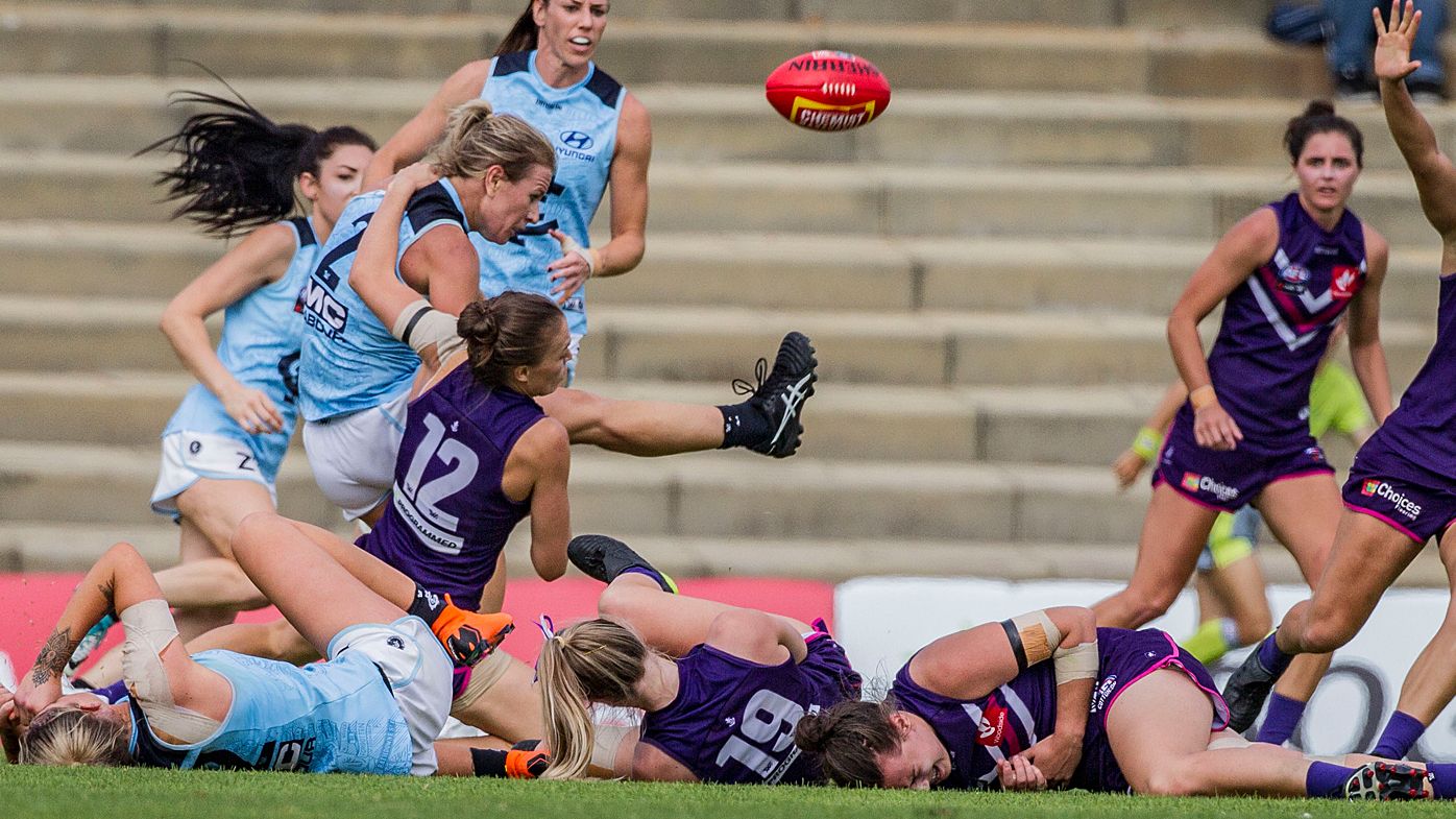 AFLW players injured in heavy collision during Fremantle Dockers win over Carlton