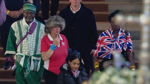 Mourners file through Westminster Hall to see Queen's coffin.