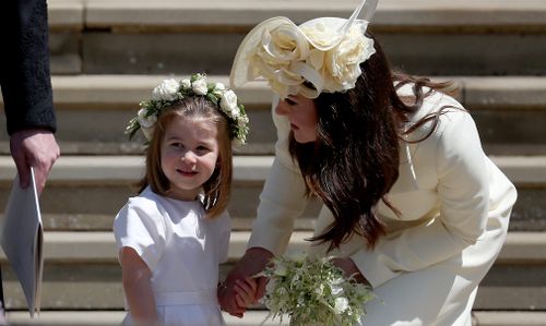 Kate Middleton, the Duchess of Cambridge, wore a demure primrose yellow wool coat by Alexander McQueen to the royal wedding. Picture: PA