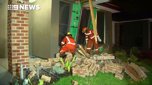 Officials inspect the damage to the home. (9NEWS)