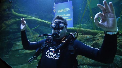 Tim Nicholls goes underwater to spruik his tourism message. (AAP)