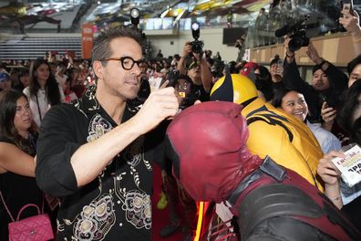 Actor Ryan Reynolds signs an autograph for fans during the red carpet event to promote his latest movie "Deadpool & Wolverine" in Seoul, South Korea, Thursday, July 4, 2024. 