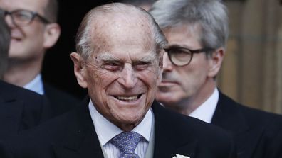 Britain's Prince Philip, center, stands with other guests as he prepares to leave the chapel after the wedding of Lady Gabriella Windsor.