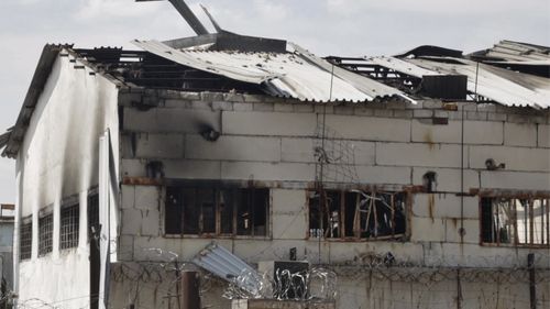 In this photo taken from video a view of a destroyed barrack at a prison in Olenivka, in an area controlled by Russian-backed separatist forces, eastern Ukraine, Friday, July 29, 2022. Russia and Ukraine accused each other Friday of shelling a prison in a separatist region of eastern Ukraine, an attack that reportedly killed dozens of Ukrainian military prisoners who were captured after the fall of a southern port city of Mariupol in May. (AP Photo)