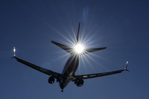 A Southwest plane flies low over Gravelly Point on approach to Ronald Reagan Washington National Airport in Arlington, Va., Friday, Dec. 30, 2022.