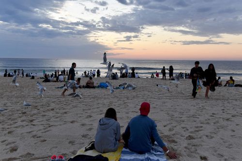 Revellers during the sunrise on New Year’s Day at Bondi Beach in Sydney.