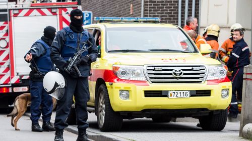 Heavily-armed forces carry out major raids in Brussels, as police release five of seven Paris attacks suspects 