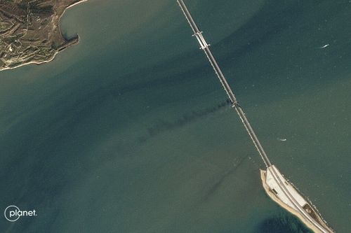 This Planet Labs satellite image shows a plume of smoke after an explosion caused the partial collapse of a bridge linking the Crimean Peninsula with Russia, damaging a key supply artery for the Kremlin's faltering war effort in southern Ukraine, Saturday, Oct. 8, 2022.