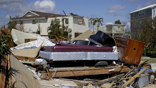 A bed sits amongst the remains of its room in a home demolished from Hurricane Irma in Goodland. (Associated Press)