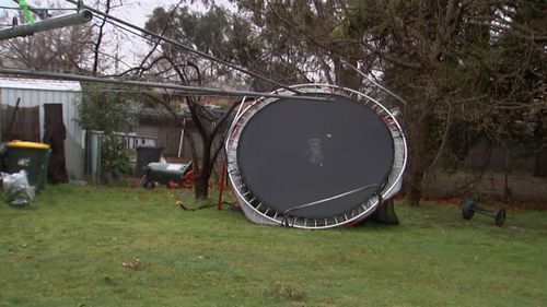 A trampoline was upended in a backyard in the wild weather.