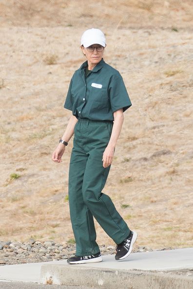 Felicity Huffman seen in green prison scrubs while carrying out her sentence for her involvement in the college admissions scandal at the Federal Correctional Institution (FCI) in Dublin, Northern California