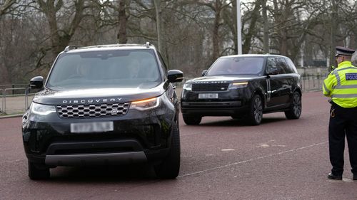 A convoy of cars believed to be carrying Prince Harry arrive at Clarence House following the announcement of King Charles III's cancer diagnosis, in London, Tuesday, Feb. 6, 2024