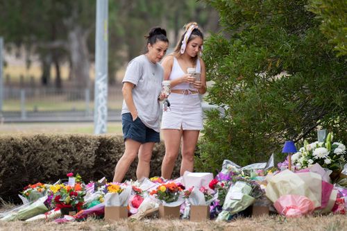 People leave floral tributes where the body of Isreali student Aiia Maasarwe was found near the Polaris Shopping centre in Bundoora, Melbourne.