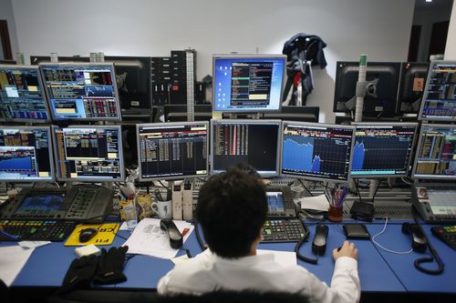 The US stock market has everyone on edge, with this broker in Paris keeping a close eye on movements overnight. (AAP)